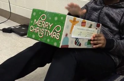 Picture of Student opening Christmas present